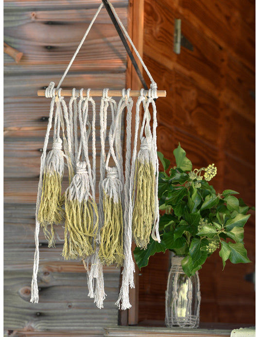 Détail des pompons de la suspension en bois décoration bohème pour mariage