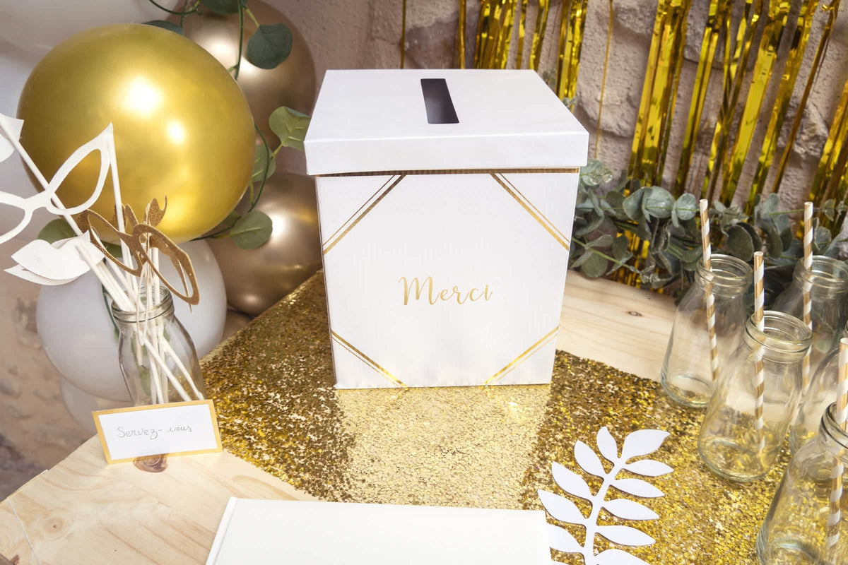 Mise en scène sur table de fête de l'urne en carton merci pour mariage
