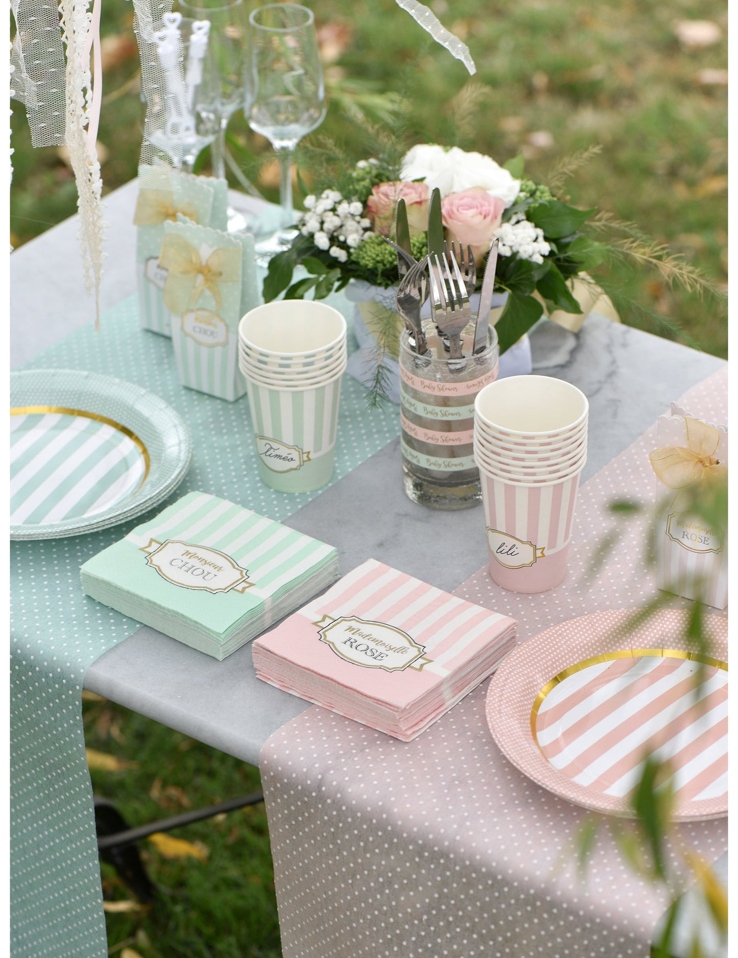 Vue d'ensemble de la table avec les serviettes en papier Mademoiselle rose pour baby shower rose à rayures blanches