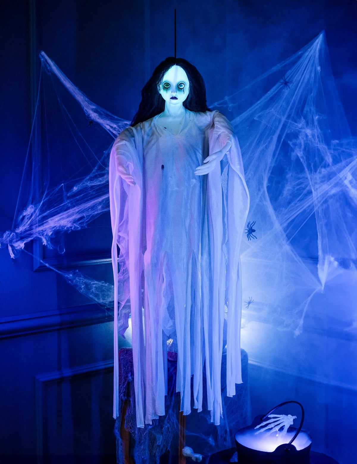 Yötilanne ripustettavalla koristeella, noita-akattilalla ja valkoisella kummituksella halloweenia varten