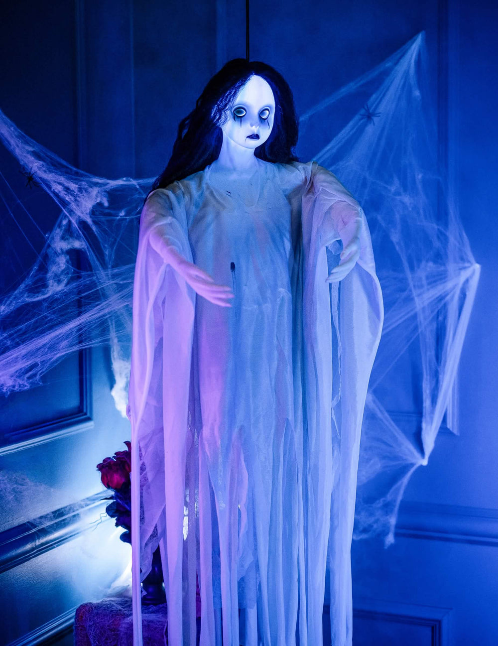 Sijoitus hämähäkeillä koristeltavien ripustettavien valkopukuisen naisen kanssa halloweenia varten