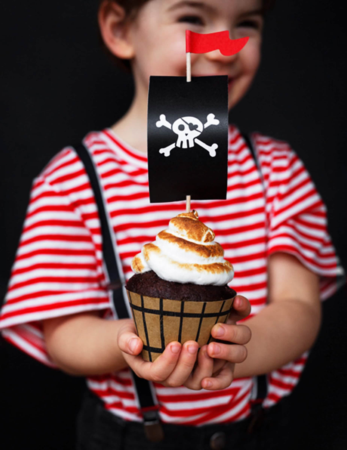 cupcake-juhlapakkaus merirosvojuhliin lapsille musta ja punainen pääkallolipulla