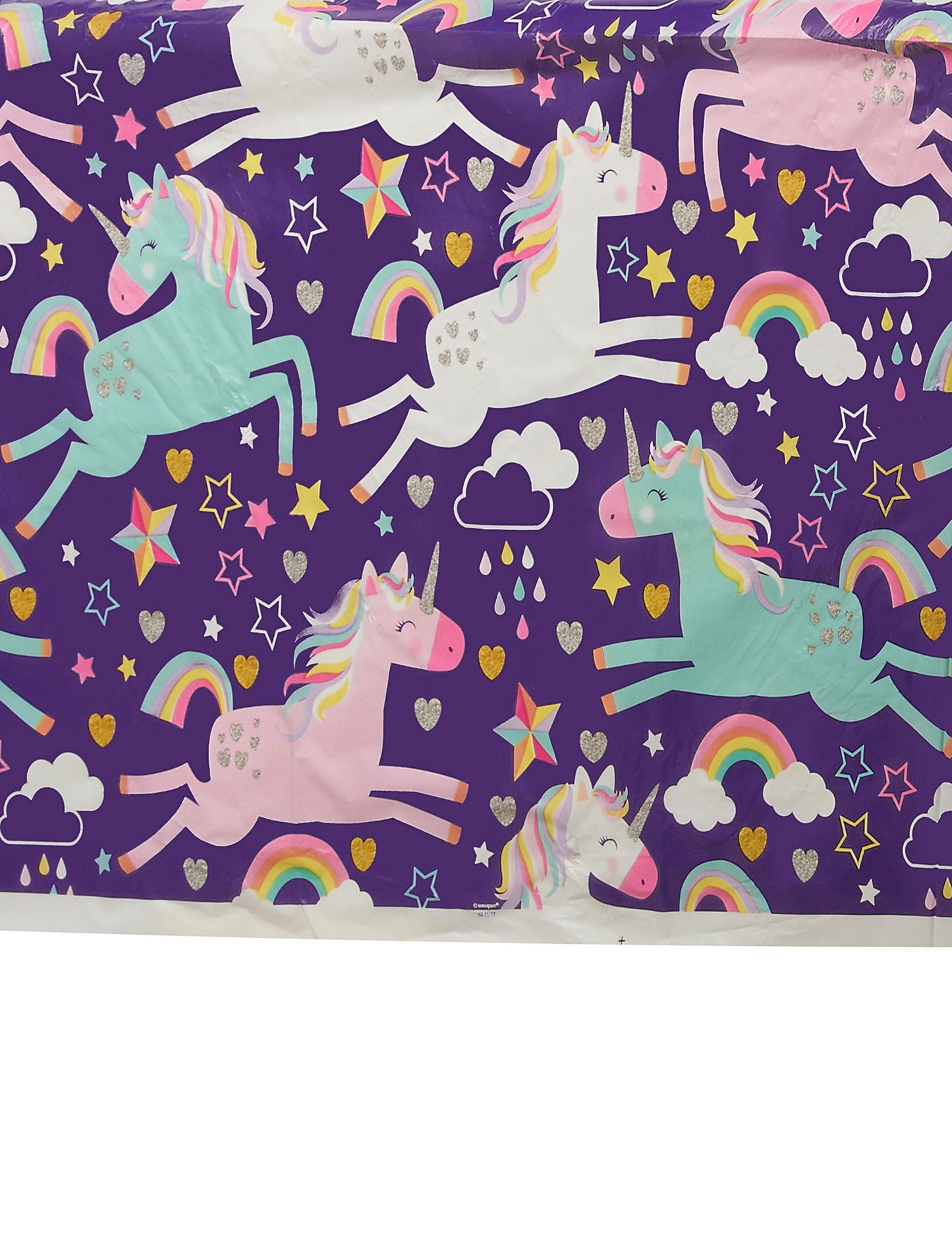 Détail des motifs de licornes et d'arcs-en-ciel de la nappe en plastique licorne party